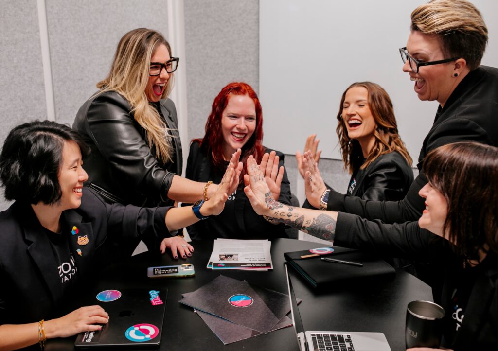 The dozanü team giving high-fives.